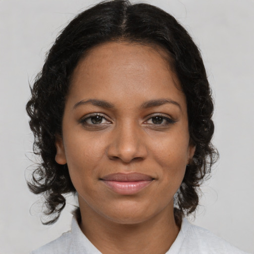 Joyful black young-adult female with medium  brown hair and brown eyes