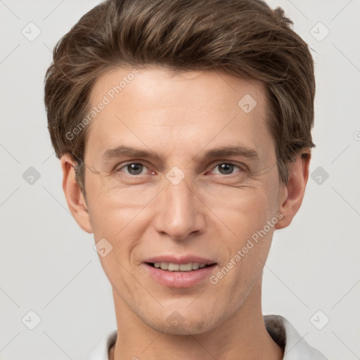 Joyful white adult male with short  brown hair and grey eyes