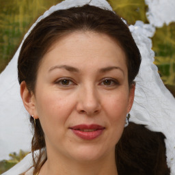 Joyful white adult female with medium  brown hair and brown eyes