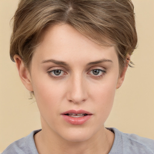 Joyful white young-adult female with short  brown hair and grey eyes