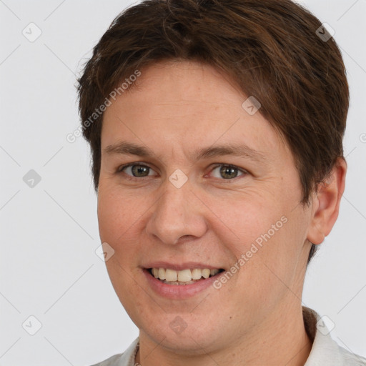 Joyful white adult male with short  brown hair and brown eyes