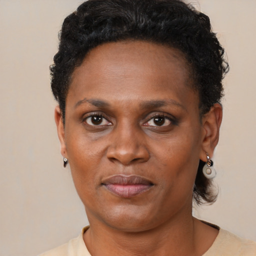 Joyful black adult female with short  brown hair and brown eyes