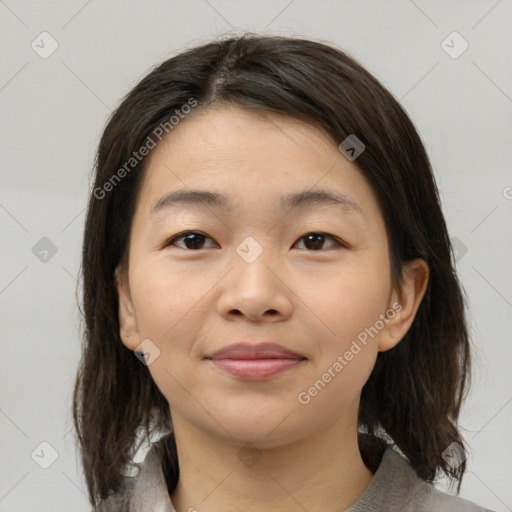 Joyful asian young-adult female with medium  brown hair and brown eyes