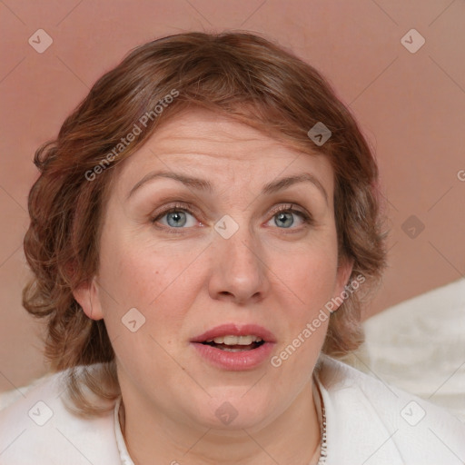 Joyful white adult female with medium  brown hair and blue eyes