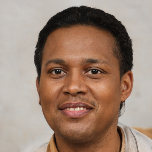 Joyful latino young-adult male with short  black hair and brown eyes
