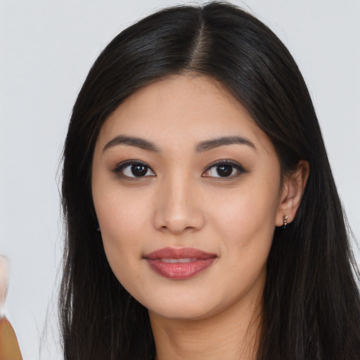Joyful asian young-adult female with long  black hair and brown eyes