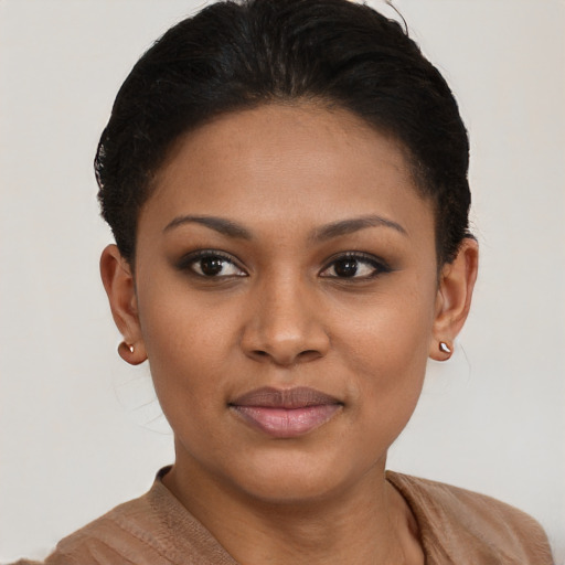 Joyful black young-adult female with short  brown hair and brown eyes