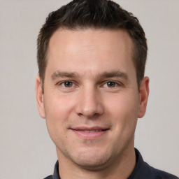 Joyful white young-adult male with short  brown hair and brown eyes