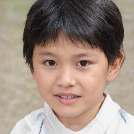 Joyful asian child male with short  brown hair and brown eyes