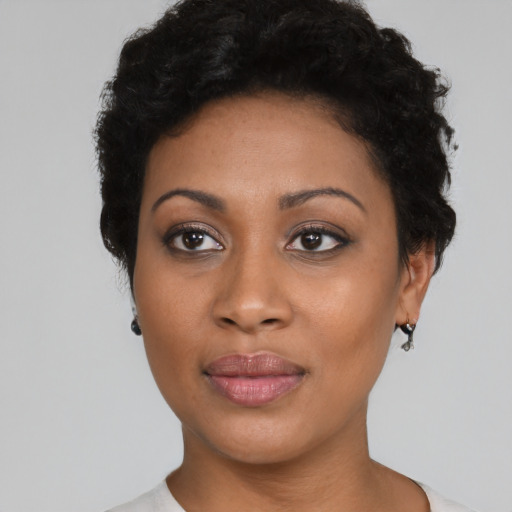 Joyful black young-adult female with short  brown hair and brown eyes