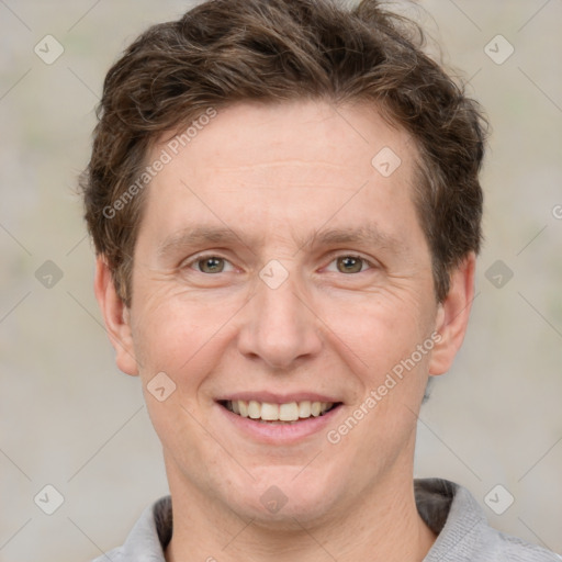 Joyful white adult male with short  brown hair and grey eyes