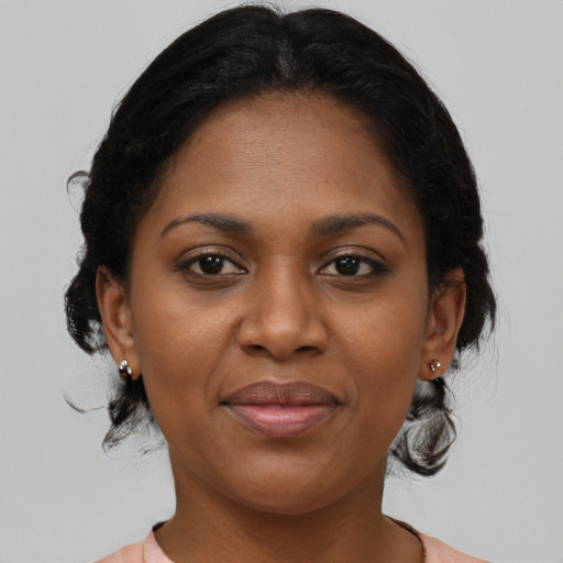 Joyful black young-adult female with medium  brown hair and brown eyes