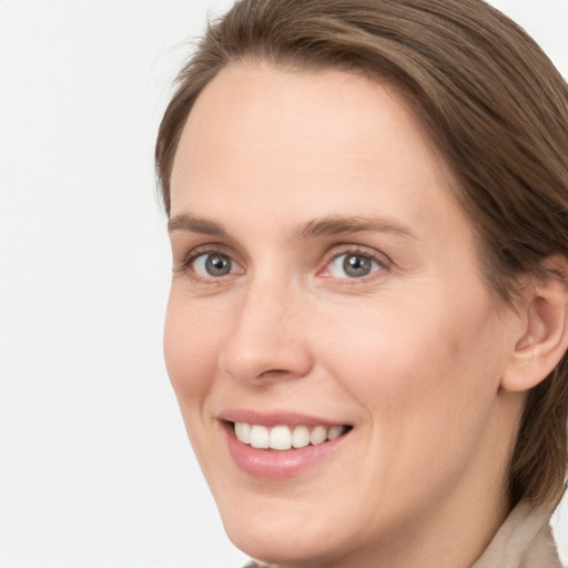 Joyful white young-adult female with long  brown hair and grey eyes