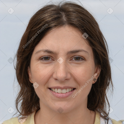 Joyful white adult female with medium  brown hair and grey eyes