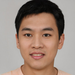 Joyful asian young-adult male with short  black hair and brown eyes