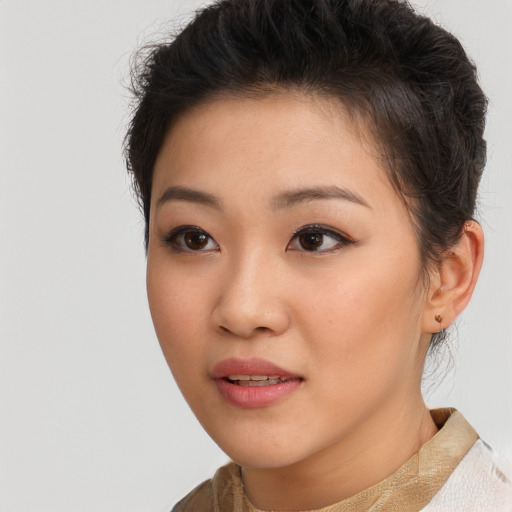 Joyful asian young-adult female with short  brown hair and brown eyes