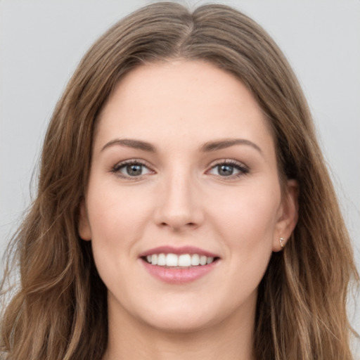 Joyful white young-adult female with long  brown hair and green eyes