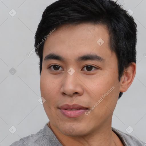 Joyful asian young-adult male with short  black hair and brown eyes