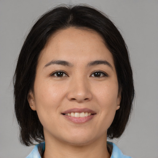 Joyful asian young-adult female with medium  brown hair and brown eyes