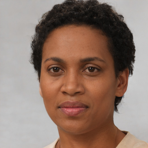 Joyful black adult female with short  brown hair and brown eyes