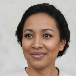 Joyful latino adult female with short  brown hair and brown eyes