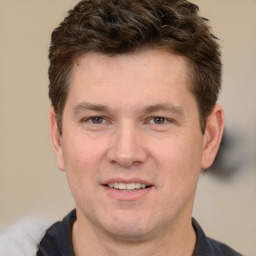 Joyful white adult male with short  brown hair and brown eyes