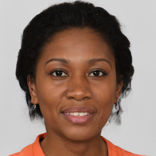Joyful black adult female with short  black hair and brown eyes