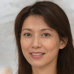 Joyful white adult female with long  brown hair and brown eyes