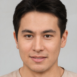 Joyful asian young-adult male with short  brown hair and brown eyes