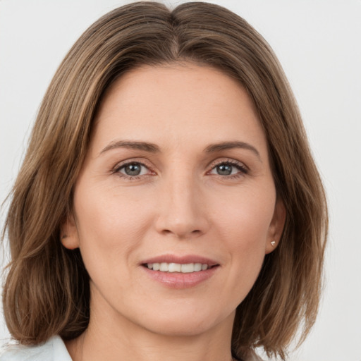 Joyful white young-adult female with medium  brown hair and green eyes