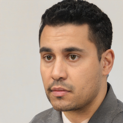 Neutral latino young-adult male with short  black hair and brown eyes