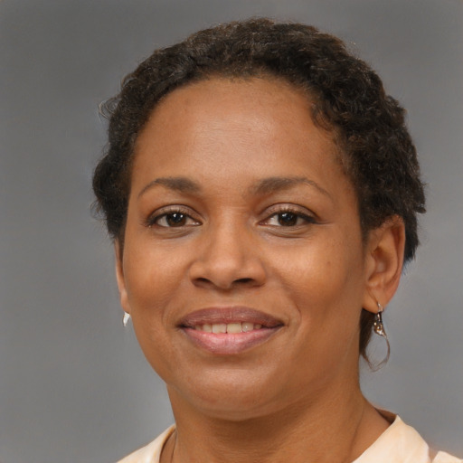 Joyful black adult female with short  brown hair and brown eyes