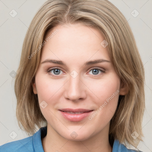 Joyful white young-adult female with medium  brown hair and blue eyes