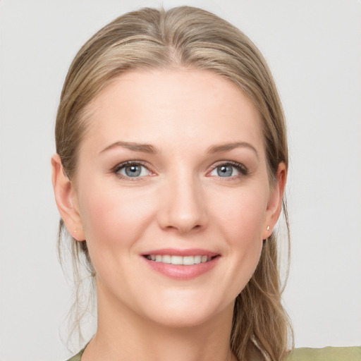 Joyful white young-adult female with long  brown hair and blue eyes