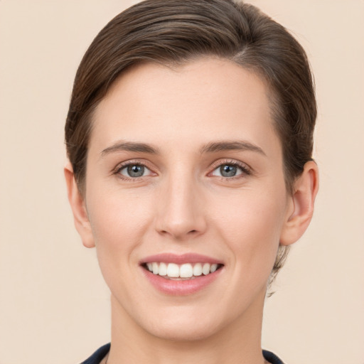 Joyful white young-adult female with short  brown hair and grey eyes