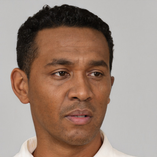 Neutral latino adult male with short  black hair and brown eyes