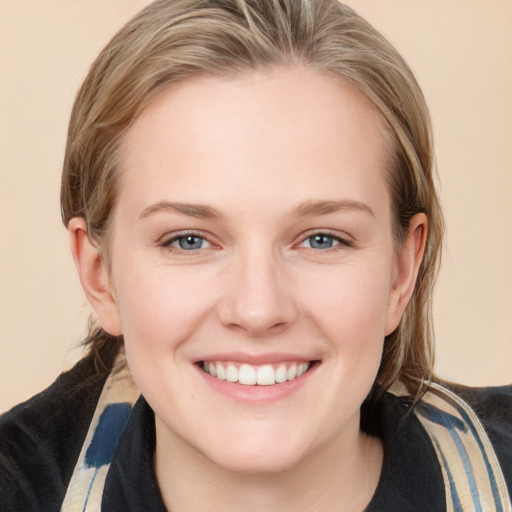 Joyful white young-adult female with medium  brown hair and blue eyes