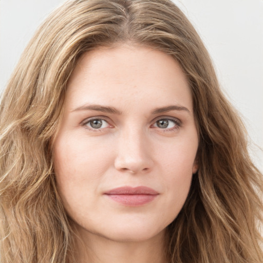 Joyful white young-adult female with long  brown hair and green eyes