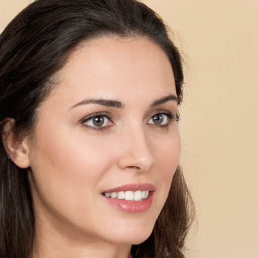 Joyful white young-adult female with long  brown hair and brown eyes