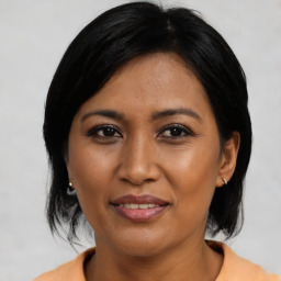 Joyful asian young-adult female with medium  black hair and brown eyes