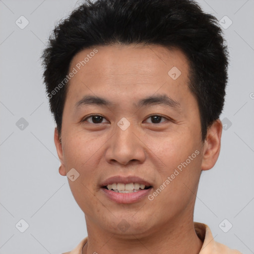 Joyful asian young-adult male with short  brown hair and brown eyes