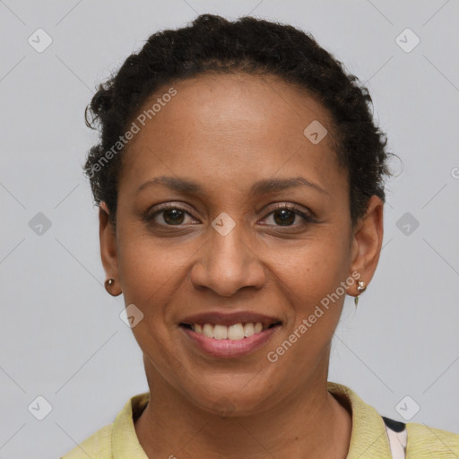 Joyful black adult female with short  brown hair and brown eyes