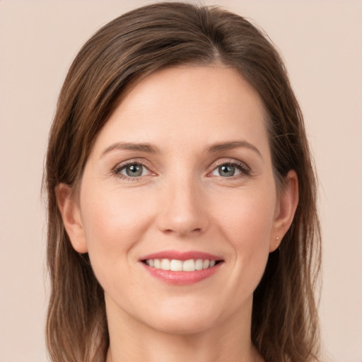 Joyful white young-adult female with long  brown hair and grey eyes