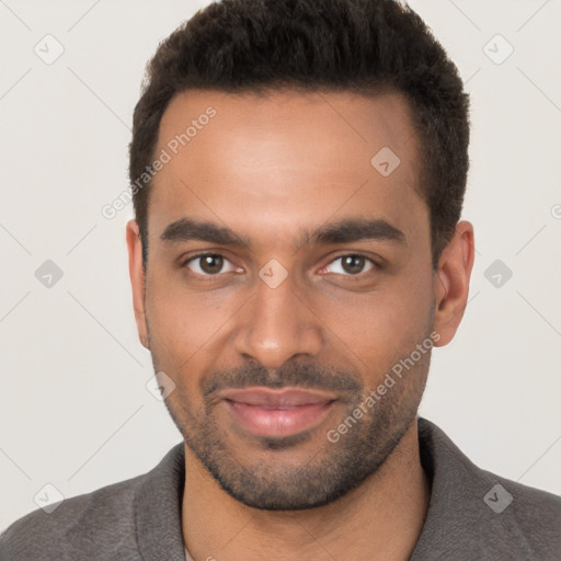 Joyful white young-adult male with short  black hair and brown eyes