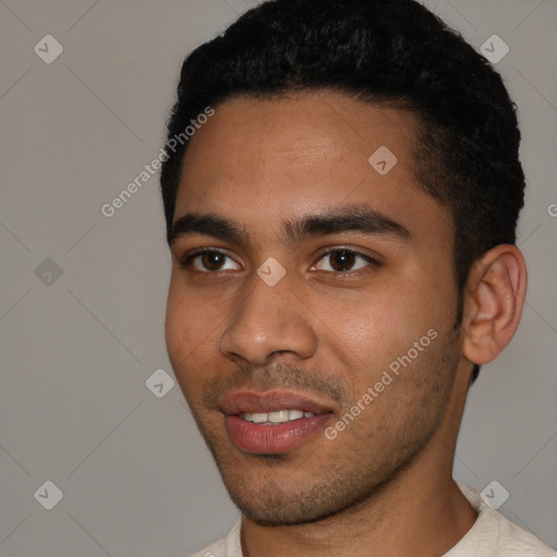 Joyful black young-adult male with short  black hair and brown eyes