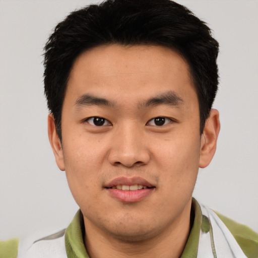 Joyful asian young-adult male with short  black hair and brown eyes