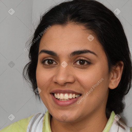 Joyful latino young-adult female with medium  brown hair and brown eyes