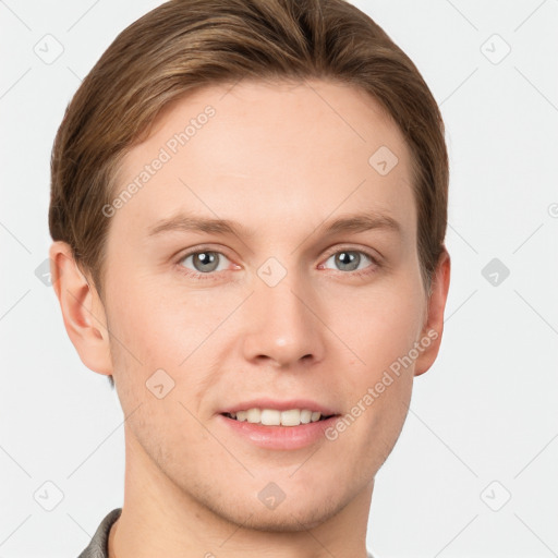 Joyful white young-adult male with short  brown hair and grey eyes