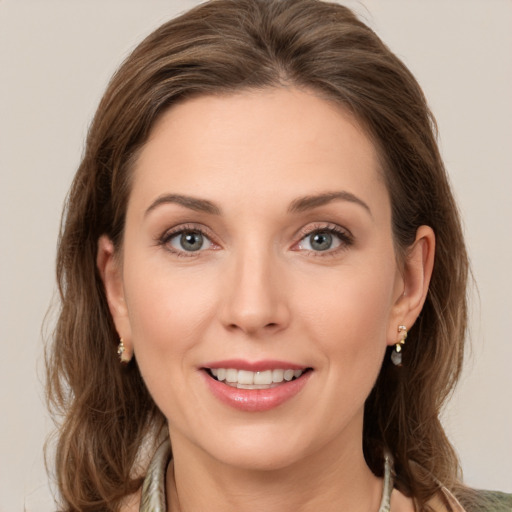 Joyful white young-adult female with medium  brown hair and green eyes