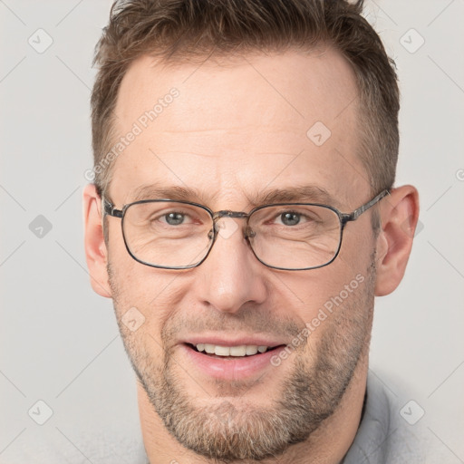 Joyful white adult male with short  brown hair and grey eyes